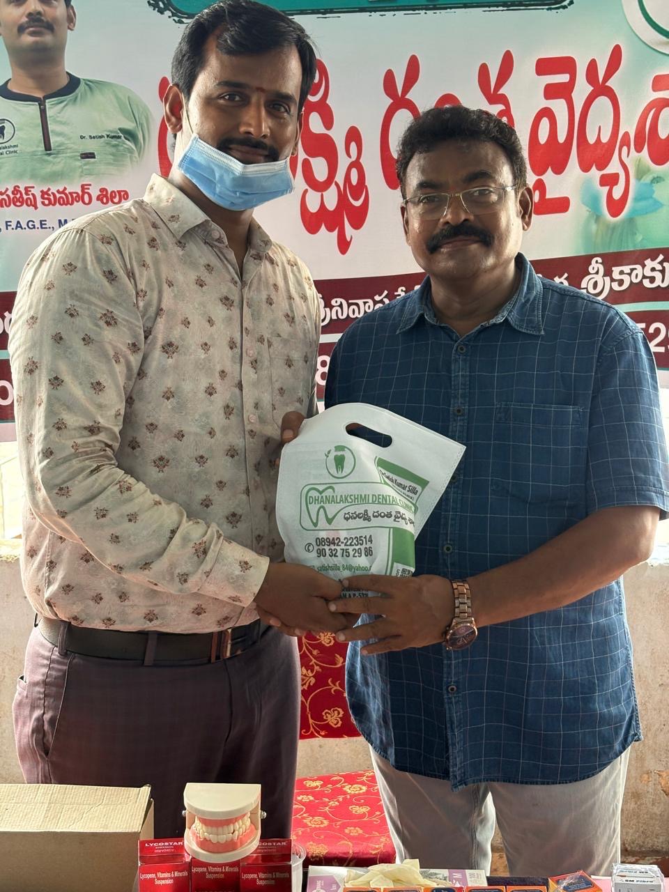 Distributing free oral hygiene kits to patients at the camp